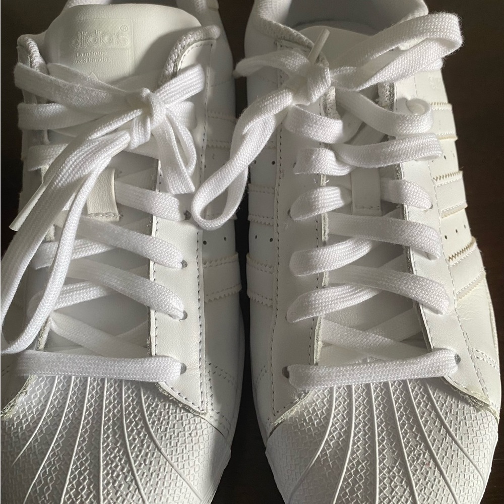 White Adidas Superstar sneakers size Woman’s size 8 1/2. Never worn